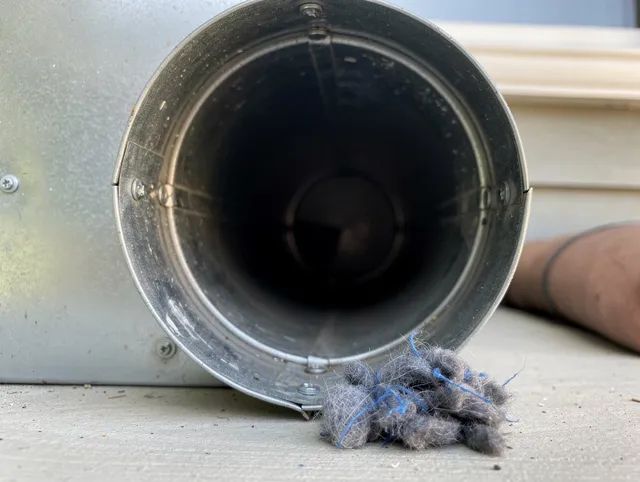 Arcadia Dryer Vent Cleaning technician using specialized equipment to clear severe dryer vent blockage in Arcadia